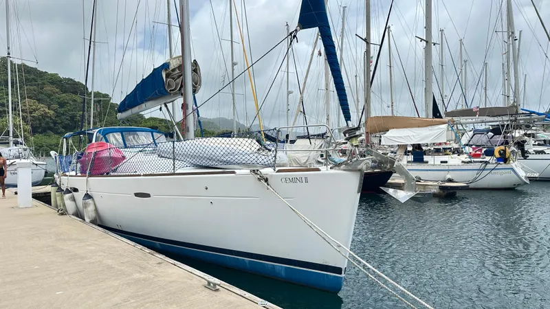  Yacht Photos Pics 2010 Beneteau Oceanis 50 sailboat docked in a marina, surrounded by other boats.