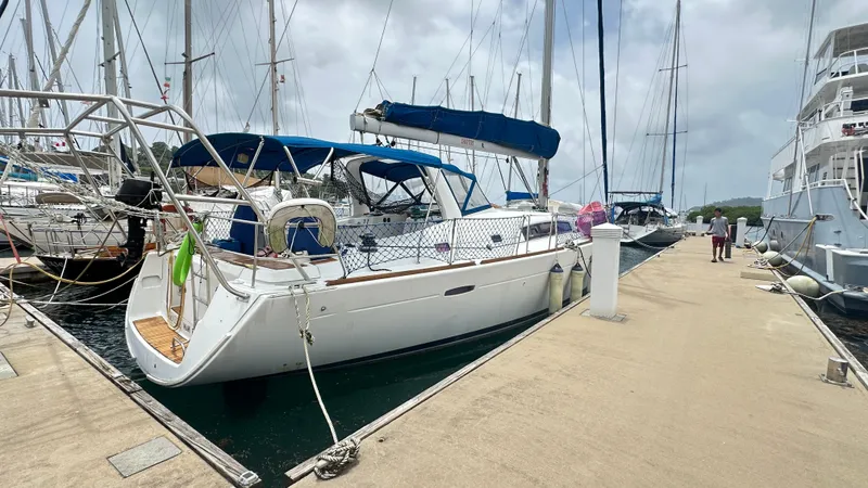  Yacht Photos Pics 2010 Beneteau Oceanis 50 sailboat docked at marina under cloudy sky.