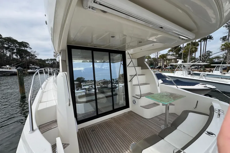  Yacht Photos Pics 2014 Prestige 400 yacht deck with seating, glass table, and marina view.