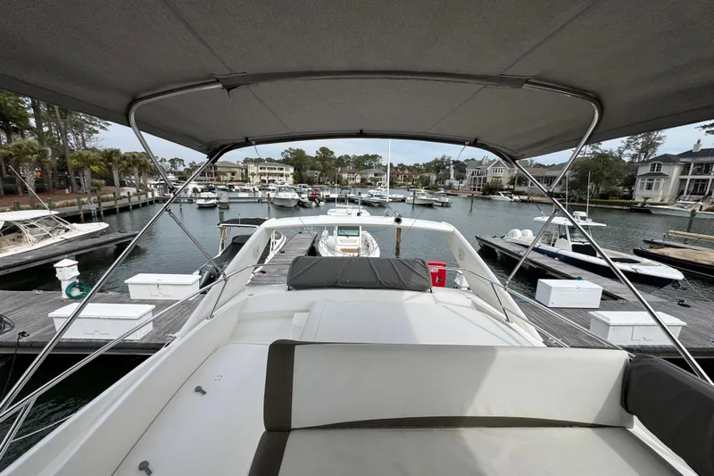  Yacht Photos Pics 2014 Prestige 400 yacht docked in a marina, surrounded by boats and waterfront homes.