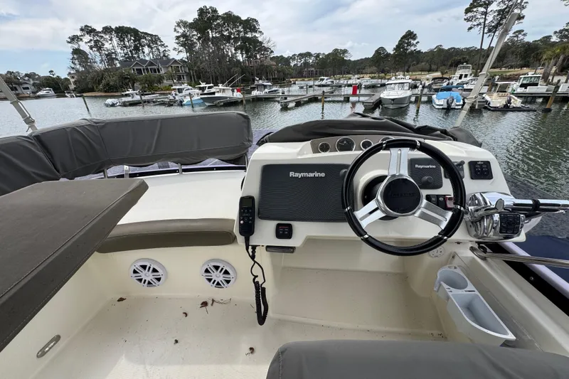  Yacht Photos Pics Helm of 2014 Prestige 400 yacht with Raymarine equipment, docked in a scenic marina.