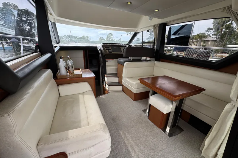  Yacht Photos Pics Luxurious interior of a 2014 Prestige 400 yacht with elegant seating and wooden table.