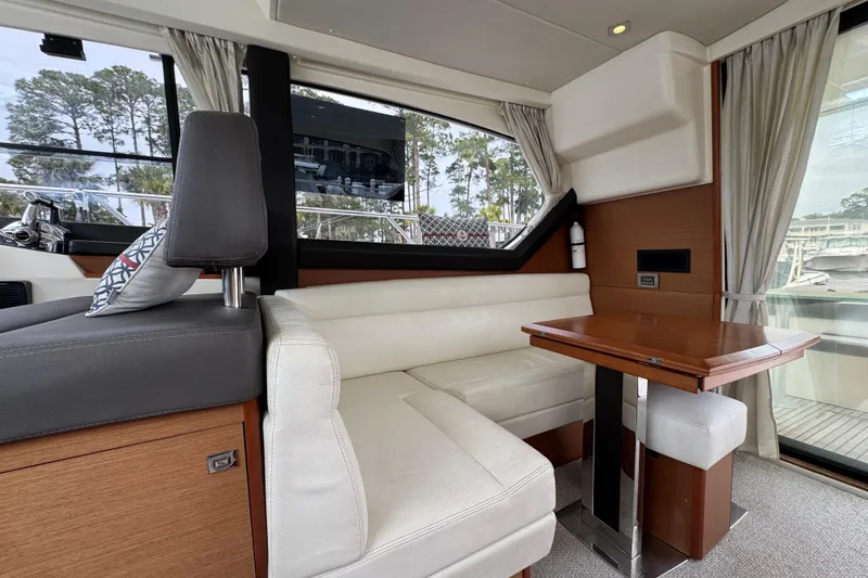  Yacht Photos Pics Luxurious interior of 2014 Prestige 400 yacht with elegant seating and wooden table.