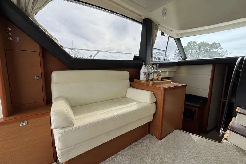  Yacht Photos Pics Luxurious interior of 2014 Prestige 400 yacht with cream seating and wooden accents.