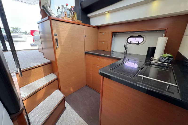  Yacht Photos Pics Luxurious 2014 Prestige 400 yacht kitchen with modern wood cabinetry and sleek black countertops.