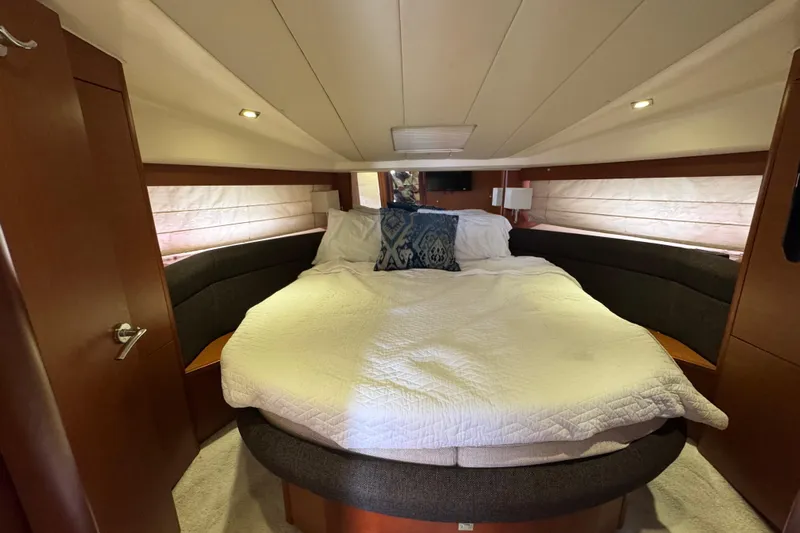  Yacht Photos Pics Luxurious bedroom interior of 2014 Prestige 400 yacht with cozy bedding and ambient lighting.