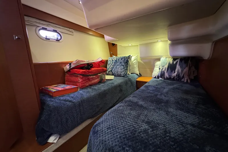  Yacht Photos Pics Cozy cabin interior of 2014 Prestige 400 yacht with twin beds and decorative pillows.