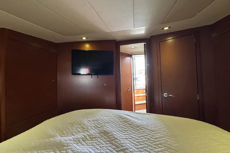 Yacht Photos Pics Luxurious interior of 2014 Prestige 400 yacht with TV and cozy bedding.