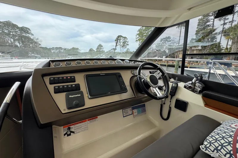  Yacht Photos Pics Helm of 2014 Prestige 400 yacht with navigation controls and steering wheel.
