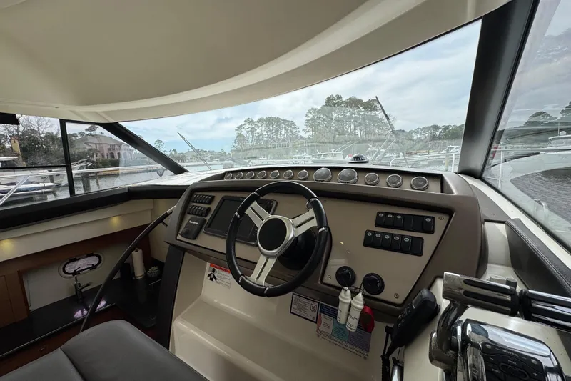  Yacht Photos Pics Interior view of a 2014 Prestige 400 yacht helm with steering wheel and control panel.