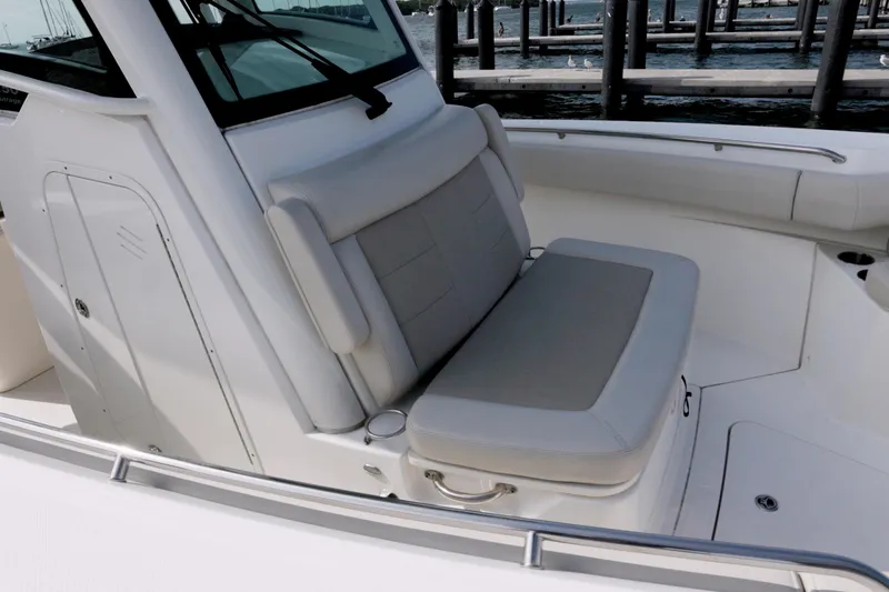 250 Outrage Yacht Photos Pics 2022 Boston Whaler 250 Outrage boat interior with cushioned seating and sleek design.