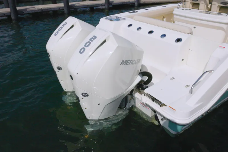 250 Outrage Yacht Photos Pics 2022 Boston Whaler 250 Outrage with dual Mercury outboard engines in water.