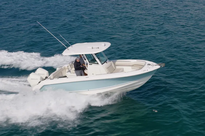 250 Outrage Yacht Photos Pics 2022 Boston Whaler 250 Outrage cruising on open water, showcasing sleek design and performance.