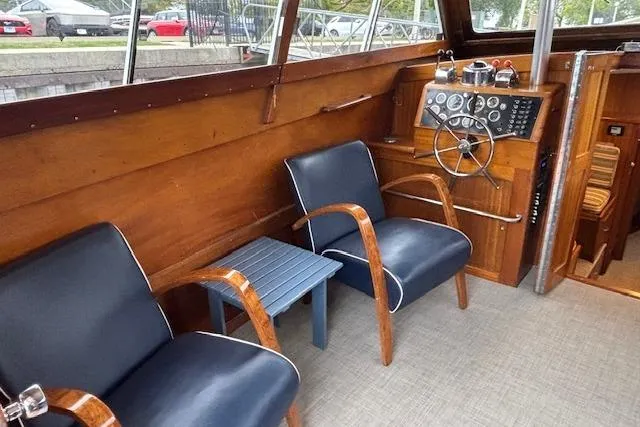 Interior of a 1964 Pacemaker 36 Sportfisherman boat with wooden helm and seating.