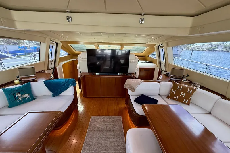 Olivia K Yacht Photos Pics Luxurious interior of a 2005 Mangusta 92 yacht with elegant seating and large windows.