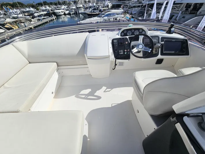  Yacht Photos Pics Flybridge of 2013 Princess 52 yacht with helm, seating, and marina view.