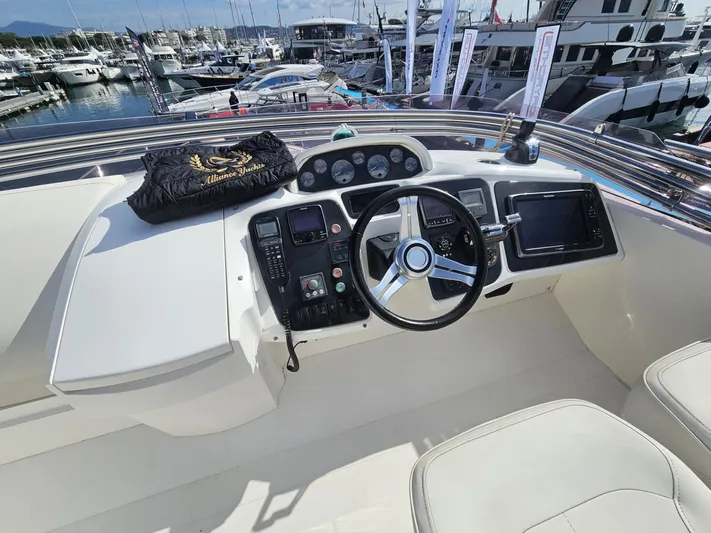  Yacht Photos Pics Flybridge helm of 2013 Princess 52 yacht, featuring modern controls and marina view.