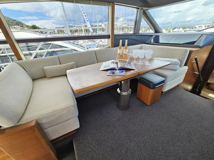  Yacht Photos Pics Luxurious interior of 2013 Princess 52 Flybridge yacht with elegant seating and table setting.
