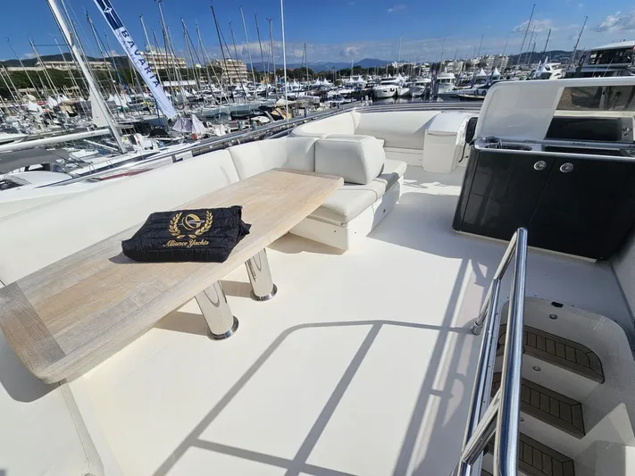  Yacht Photos Pics Flybridge of 2013 Princess 52 yacht with seating and table, docked in marina.