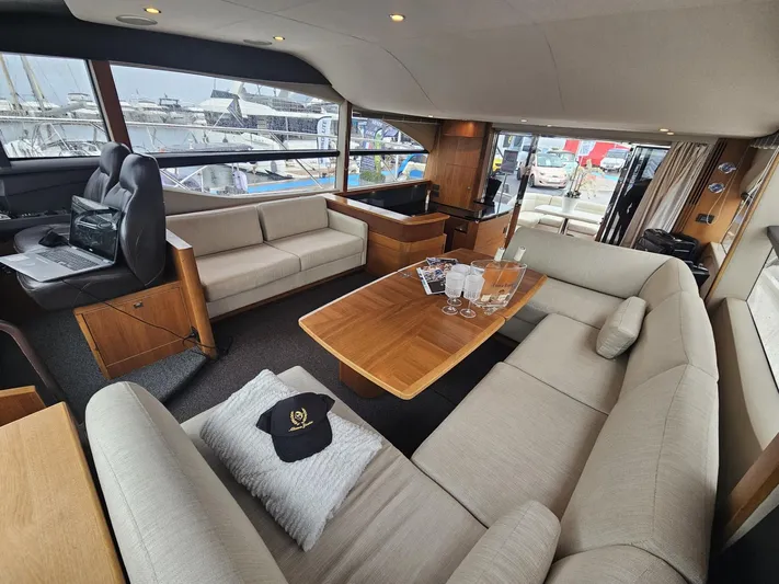  Yacht Photos Pics Luxurious interior of 2013 Princess 52 Flybridge yacht with elegant seating and wooden table.
