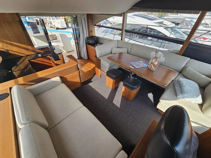  Yacht Photos Pics Luxurious interior of 2013 Princess 52 Flybridge yacht with elegant seating and dining area.