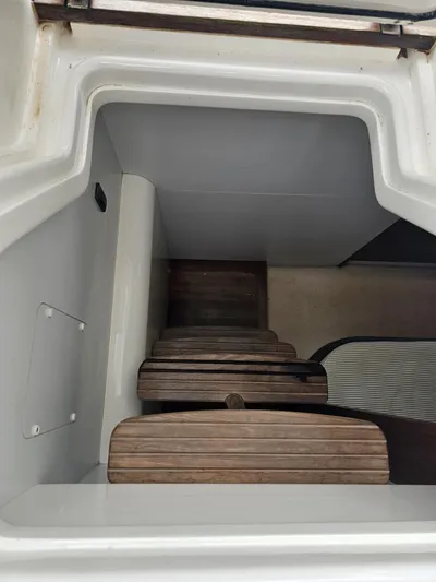  Yacht Photos Pics Staircase on 2013 Princess 52 Flybridge yacht, featuring wooden steps and white interior.