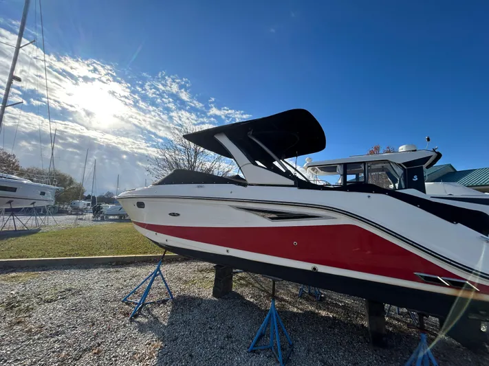  Yacht Photos Pics 2018 Sea Ray SLX 280 boat on stands under a clear blue sky.
