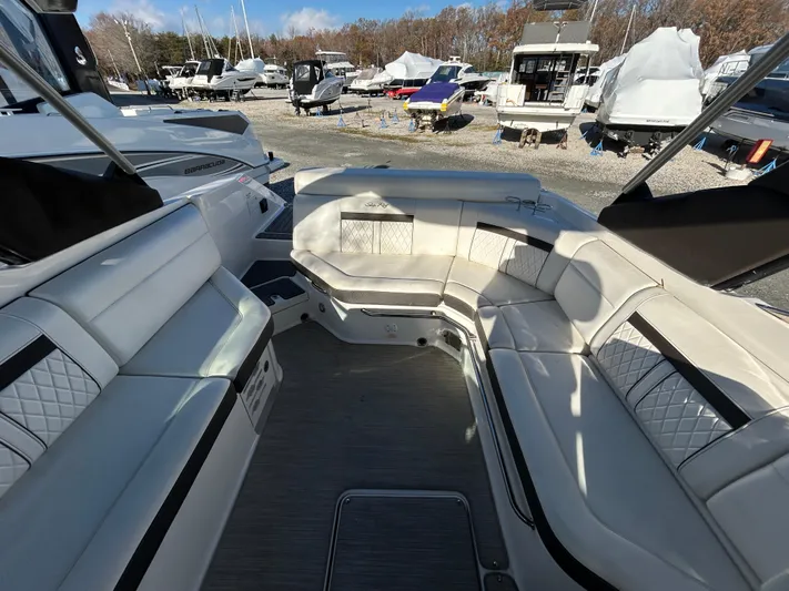  Yacht Photos Pics 2018 Sea Ray SLX 280 boat interior with white seating and outdoor marina view.