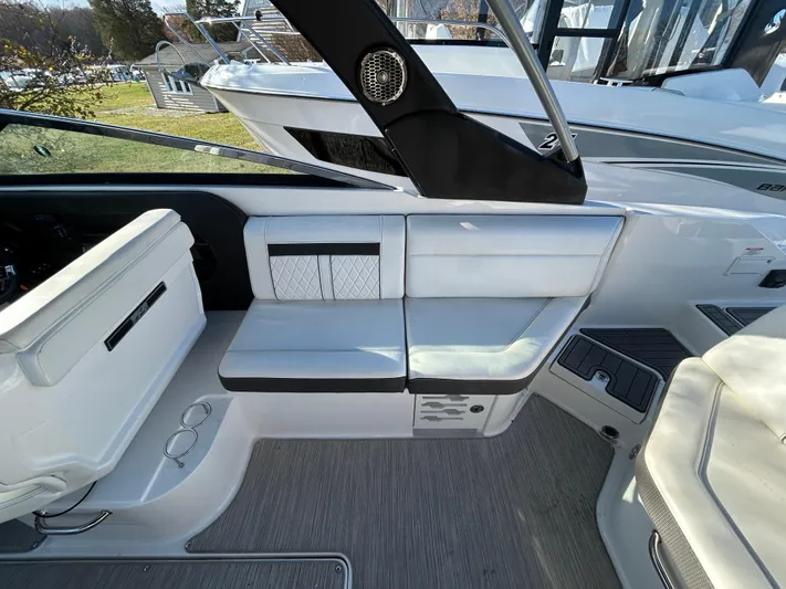  Yacht Photos Pics Interior seating of a 2018 Sea Ray SLX 280 boat, featuring white upholstery and modern design.