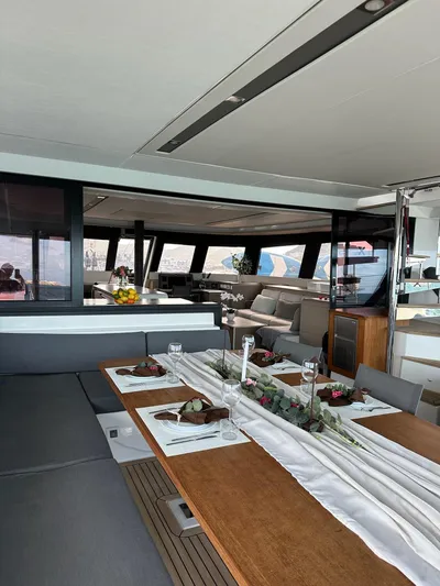  Yacht Photos Pics Luxurious interior of 2020 Fountaine Pajot Samana 59 yacht with elegant dining setup.
