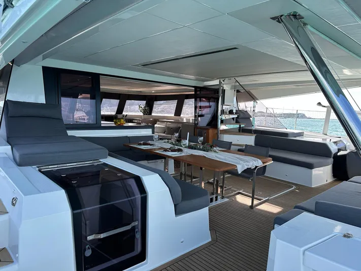  Yacht Photos Pics Luxurious 2020 Fountaine Pajot Samana 59 yacht interior with elegant seating and dining area.