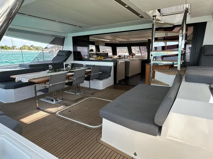  Yacht Photos Pics Luxurious interior of 2020 Fountaine Pajot Samana 59 yacht with elegant seating and dining area.