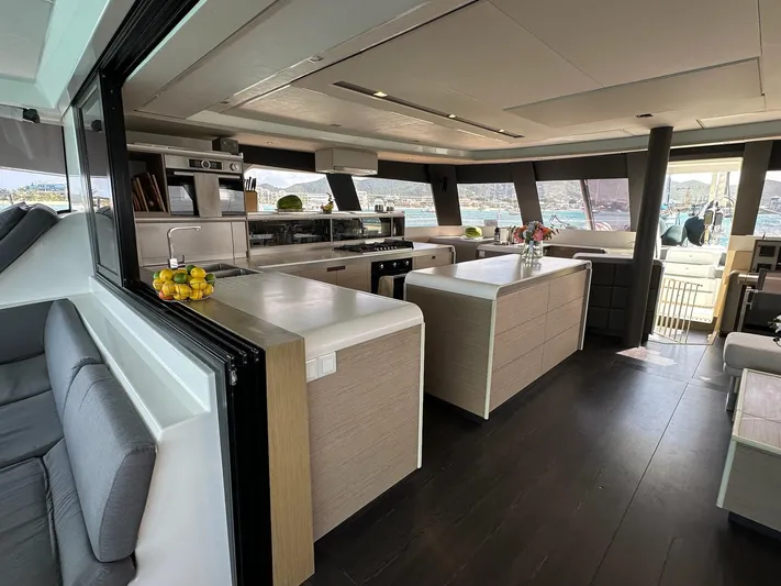  Yacht Photos Pics Luxurious interior of 2020 Fountaine Pajot Samana 59 yacht with modern kitchen and seating area.