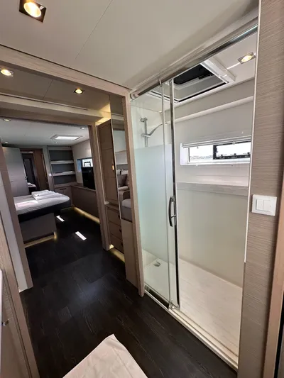  Yacht Photos Pics Interior of 2020 Fountaine Pajot Samana 59 yacht, featuring modern shower and bedroom.