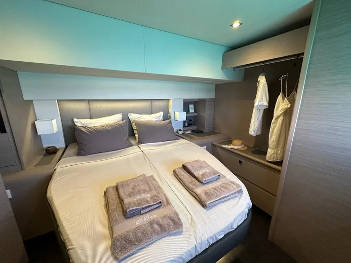  Yacht Photos Pics Luxurious bedroom interior of 2020 Fountaine Pajot Samana 59 yacht with neatly arranged linens.