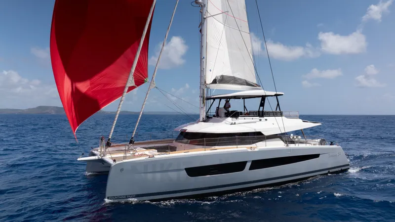  Yacht Photos Pics Fountaine Pajot Samana 59 catamaran sailing on open sea with red and white sails.