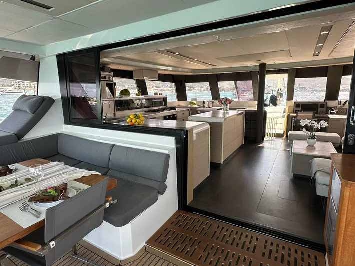  Yacht Photos Pics Luxurious interior of 2020 Fountaine Pajot Samana 59 catamaran with modern dining and kitchen area.