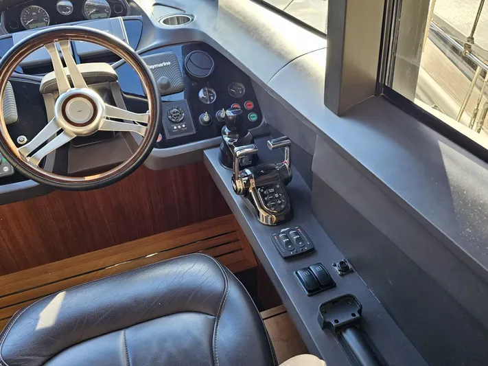  Yacht Photos Pics Interior helm of 2013 Princess 52 Flybridge yacht with steering wheel and controls.