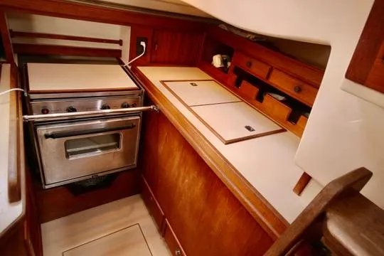 Solasta Yacht Photos Pics Island Packet 350 yacht kitchen with stove and wooden cabinetry, 1997 model.