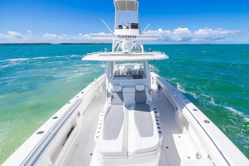  Yacht Photos Pics 2023 Invincible 37 Catamaran cruising on turquoise ocean under clear blue sky.