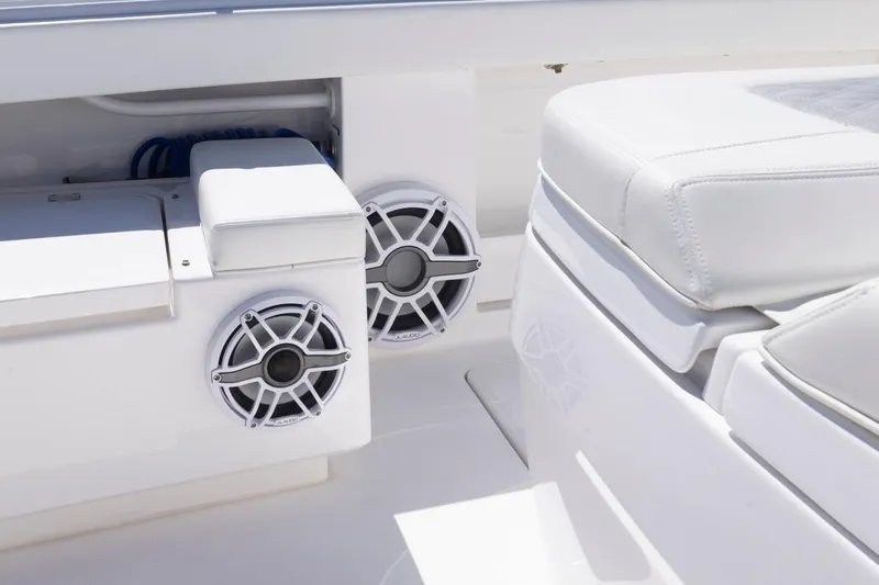  Yacht Photos Pics 2023 Invincible 37 Catamaran interior with speakers and cushioned seating.