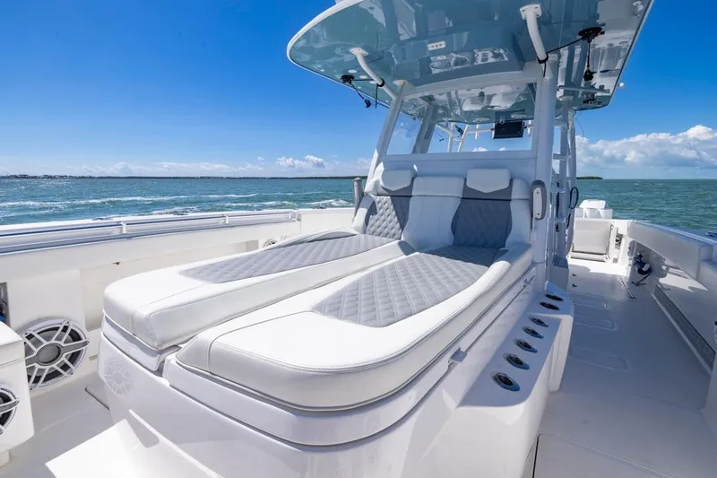  Yacht Photos Pics 2023 Invincible 37 Catamaran with luxurious seating, cruising on open water under a clear blue sky.