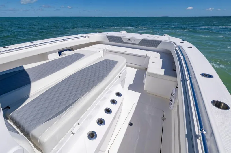  Yacht Photos Pics 2023 Invincible 37 Catamaran interior with cushioned seating, ocean view, and sleek design.