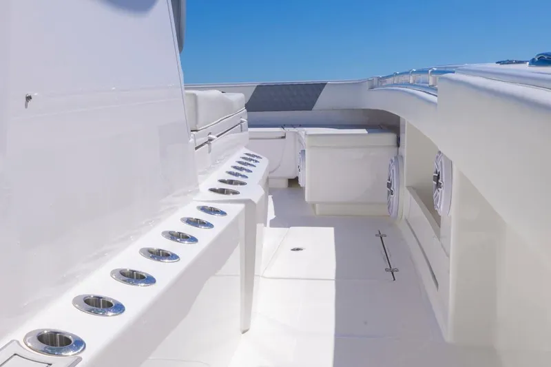  Yacht Photos Pics 2023 Invincible 37 Catamaran interior with rod holders and seating, under clear blue sky.
