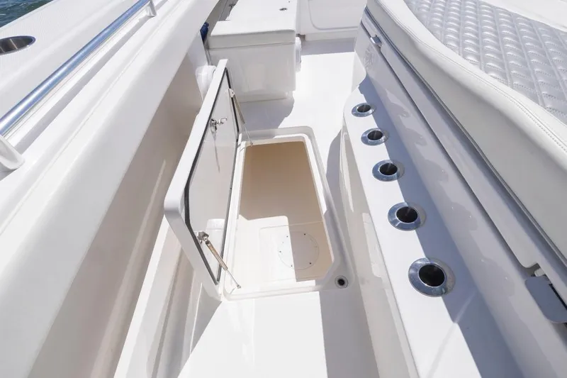  Yacht Photos Pics 2023 Invincible 37 Catamaran interior with open storage compartment and rod holders.