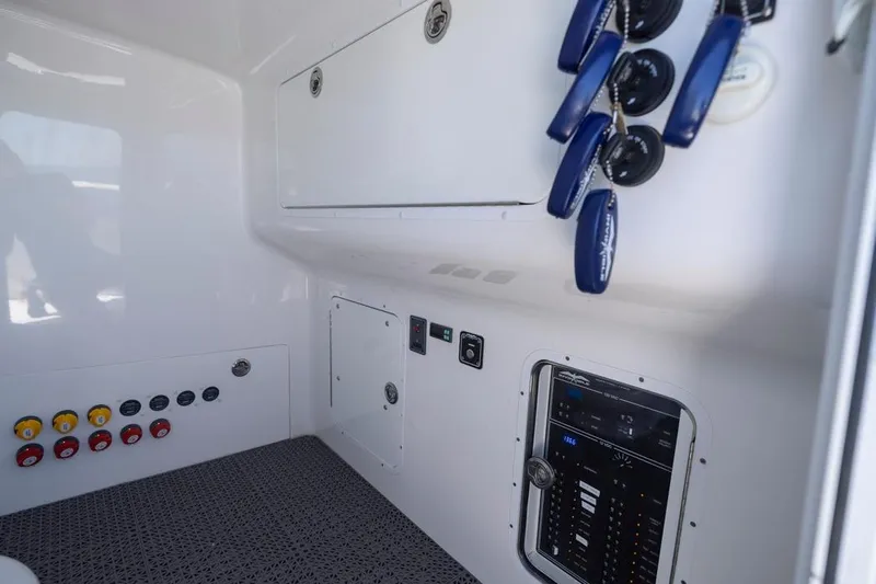  Yacht Photos Pics Interior of 2023 Invincible 37 Catamaran featuring control panel and storage compartments.