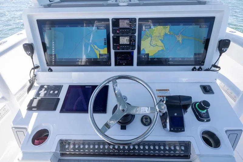  Yacht Photos Pics 2023 Invincible 37 Catamaran helm with dual navigation screens and modern controls.