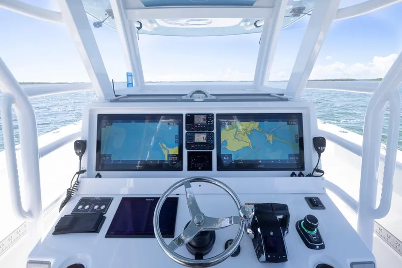  Yacht Photos Pics Helm of 2023 Invincible 37 Catamaran with dual navigation screens and steering wheel.