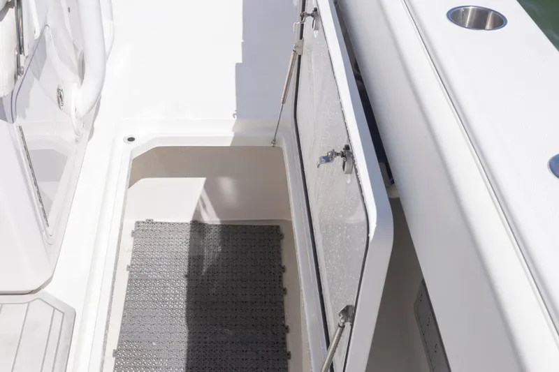  Yacht Photos Pics 2023 Invincible 37 Catamaran storage compartment with open hatch and non-slip mat.