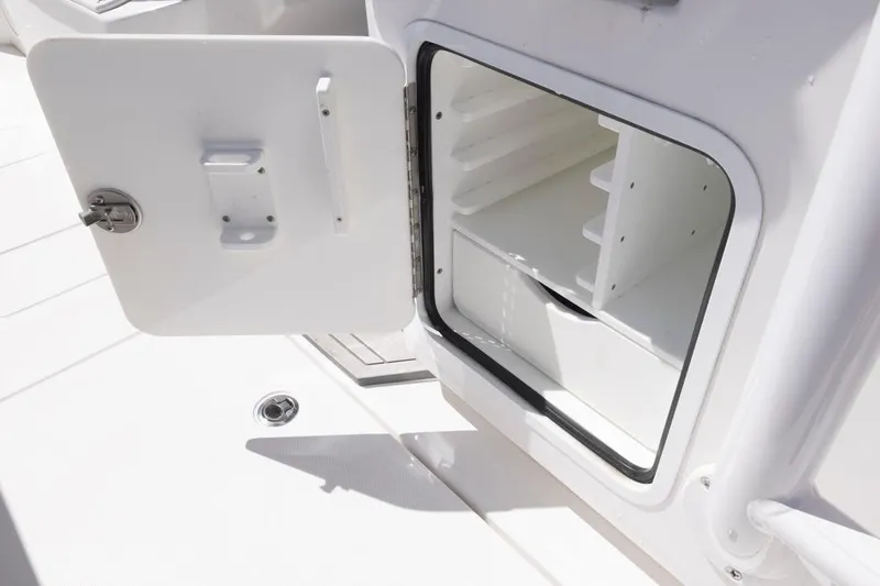  Yacht Photos Pics Open storage compartment on 2023 Invincible 37 Catamaran, showcasing interior shelving.